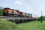 A KCS manifest crosses a low bridge north of Ganado, Texas